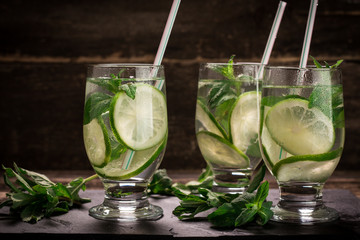 detox water with a lemon, lime and mint on a wooden table