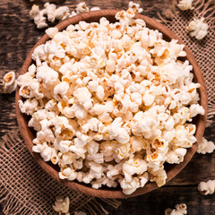 A bowl of popcorn on a wooden table