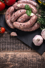 Fresh butcher cut meat assortment garnished with fresh rosemary on wooden table
