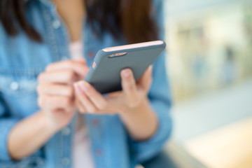 Woman sending message with smartphone