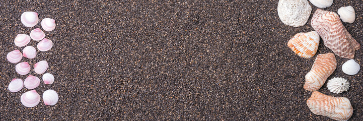 Frame made of seashells on dark sand