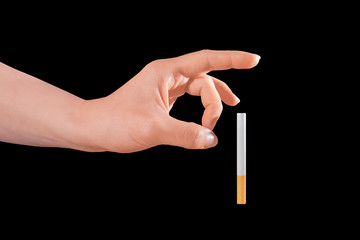 Woman trying to quit smoking by pushing it away of her isolated on black.
