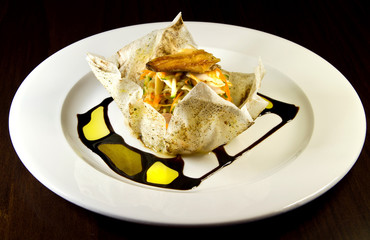 Smoked trout salad with carrots and cucumbers in filo pastry basket