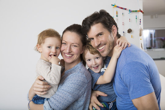 Portrait of Parents with two sons, happily smiling