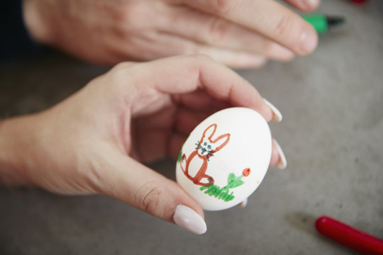 Hand holding painted Easter egg