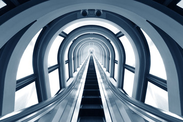 Futuristic tunnel and escalator of steel and metal, interior view