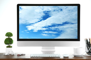 Computer on wooden table with white background. Cloud storage concept