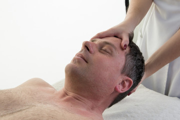 Physiotherapist doing massage and manipulation of neck of man