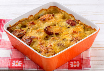 Casserole with potatoes, sausages, tomatoes and cheese.