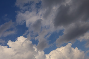Dramatic  stormy  dark and light clouds in the blue sky before rain.