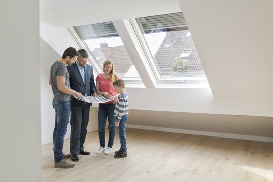 Estate agent showing family sample card in their new penthouse
