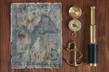 Spyglass, compass, anchor and old map