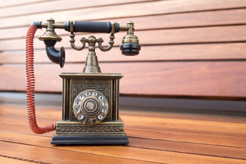 Lighter in retro classic phone model, vintage old dial Telephone on wood background