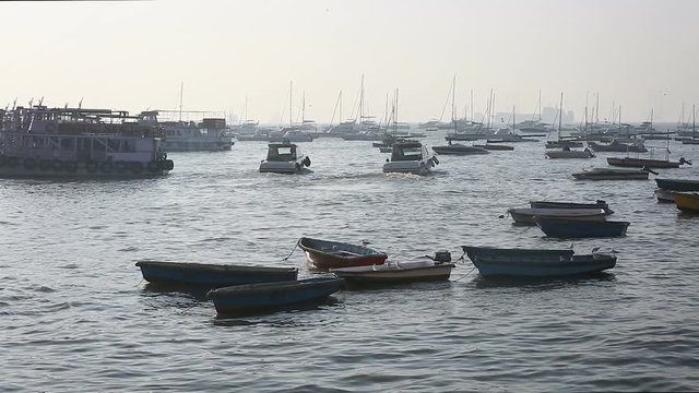 Tourist and fisher boats by the harbour