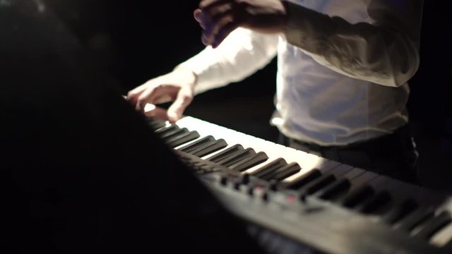 Close-Up of Male Hands Playing the Piano