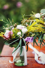 Fototapeta na wymiar Beautiful fresh wedding bouquet in glass vase closeup