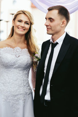 Romantic happy couple, bride & groom posing at wedding aisle