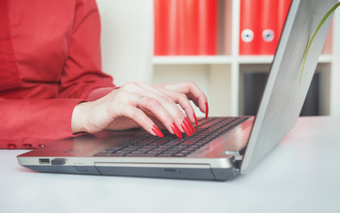 Business woman hands typing on laptop in office