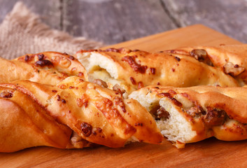 Fresh homemade small bread baguette with walnut and cheese on wooden board
