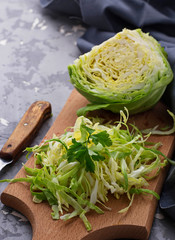 Raw cut cabbage on concrete background