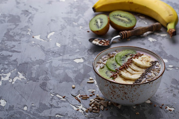 Smoothie in bowl with banana, kiwi, chia, flax and sunflower see