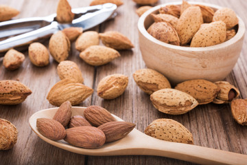 almonds set on the wooden plate, morning light
