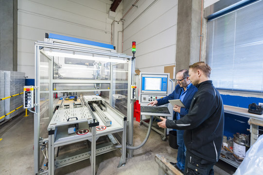 Man working at packaging machine in factory