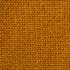 Dark goldenrod wool knitted fabric texture. Close up fragment of the top view.