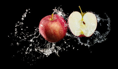 Red apples in water splash over black background - Powered by Adobe