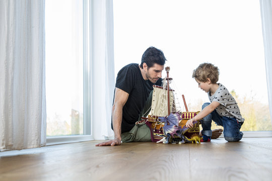 Father and son playing with toys