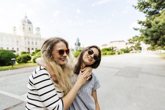 Austria, Vienna, two young women embracing at Museum of Art History