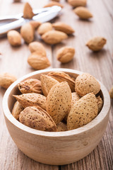 almonds set in wooden bowl, morning light,close up