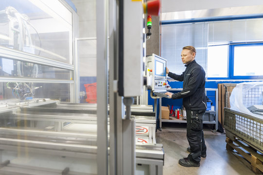 Man working at packaging machine in factory