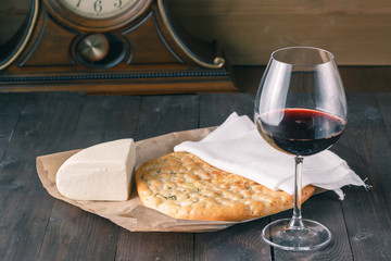 Glass of red wine with clock background