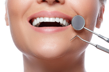 Smiling woman and dental tools
