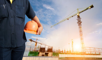 engineer holding orange helmet for workers security