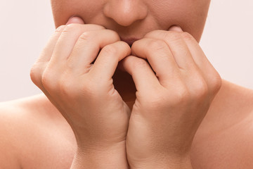 Woman bitting her fingers