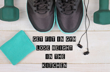 Motivation inspirational quote get Fit in Gym, lose Weight in the Kitchen.Woman workout concept. Sport, Fitness background.
