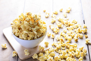 bowl of popcorn on the wooden table, selective focus