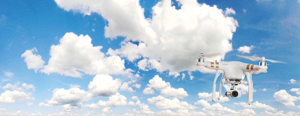 Drone with high resolution camera flying. - obrazy, fototapety, plakaty