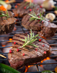 Delicious beef steaks with vegetable on a barbecue grill.