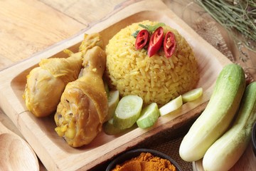 Chicken biryani with rice delicious and sauce.