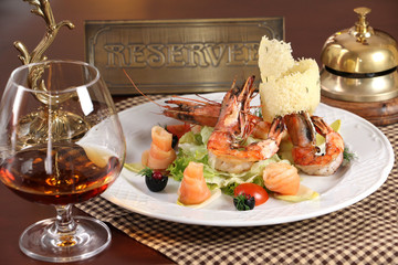 Shrimp salad with glass of cognac.