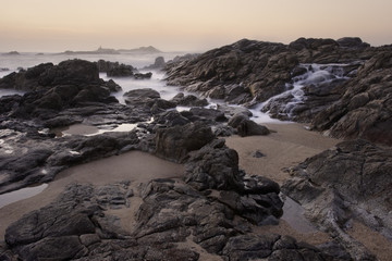 Rocky sea beach at sunset
