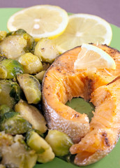 Steak of a trout with roasted brussels sprouts and lemon