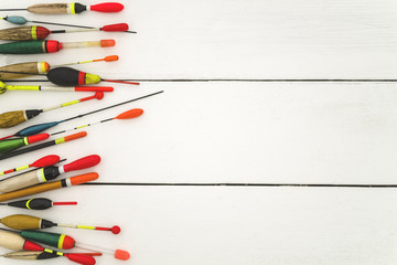Fishing floats old and new, on a wooden surface in white, lined to the left, a place for an inscription © livarnava