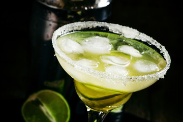 Lime Daiquiri in a glass decorated with sugar, black background,