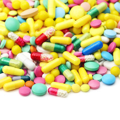 Fototapeta na wymiar Lot of different medicine pills on a white background