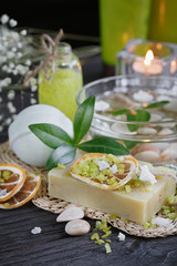 Composition of spa treatment with green salt and soap on wooden