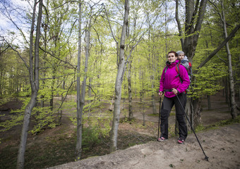 Mom walks in the forest with a child, a child in the children carry.